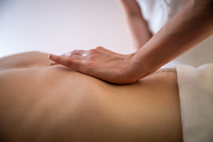 Hands massaging male abdomen.Therapist applying pressure on belly. Californian massage massage tuina du dos